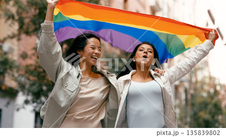 Diverse women celebrating pride, holding rainbow flag Diverse women celebrating pride, holding rainbow flag 135839802