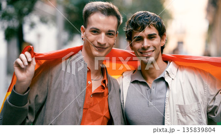 Gay couple celebrating pride with rainbow flag Gay couple celebrating pride with rainbow flag 135839804