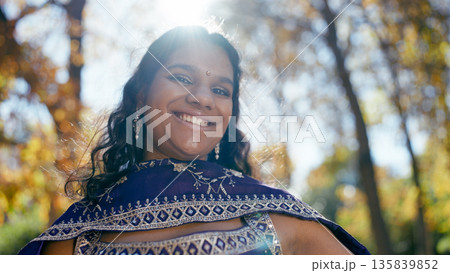 Smiling indian woman wearing traditional sari outdoors Smiling indian woman wearing traditional sari outdoors 135839852