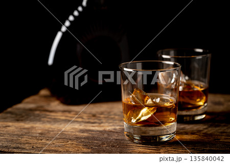 Whiskey with ice in glasses Whiskey with ice in glasses 135840042