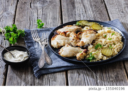 Boneless chicken thighs and couscous on a plate Boneless chicken thighs and couscous on a plate 135840196