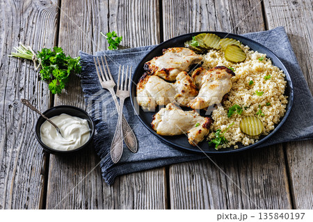 Boneless chicken thighs and couscous on a plate Boneless chicken thighs and couscous on a plate 135840197