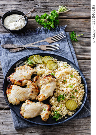Boneless chicken thighs and couscous on a plate 135840198