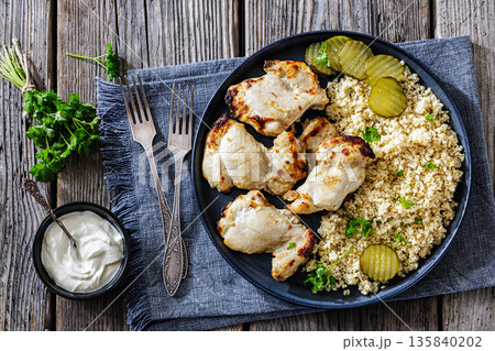 Boneless chicken thighs and couscous on a plate Boneless chicken thighs and couscous on a plate 135840202