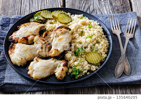 Boneless chicken thighs and couscous on a plate 135840205