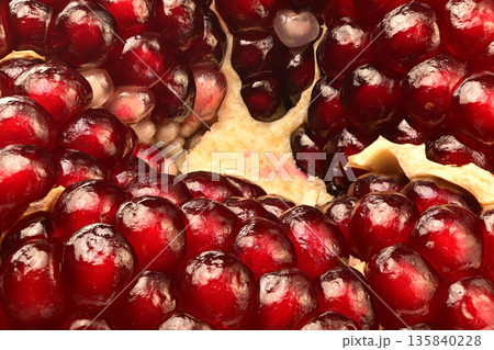 A close up of a red fruit with a lot of seeds 135840228