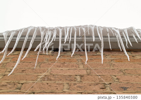 A brick wall covered in icicles A brick wall covered in icicles 135840380