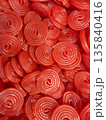 Close-up of many bright red spiral candies 135840416