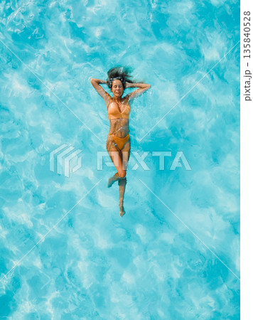 Beautiful woman float in crystal sea water, drone view of summer vacation. Beautiful woman float in crystal sea water, drone view of summer vacation. 135840528
