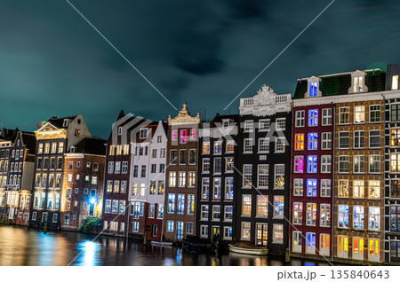 Amsterdam city at night. Old water canal houses in Netherlands 135840643