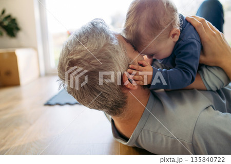 Father playing with little son on floor. Father playing with little son on floor. 135840722