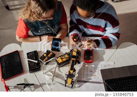 High school students working on robotics project, using online AI app to answer questions. High school students working on robotics project, using online AI app to answer questions. 135840753