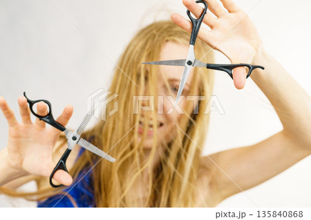 Girl with scissors for haircutting Girl with scissors for haircutting 135840868