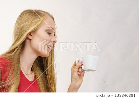 Blonde girl with coffee cup Blonde girl with coffee cup 135840881
