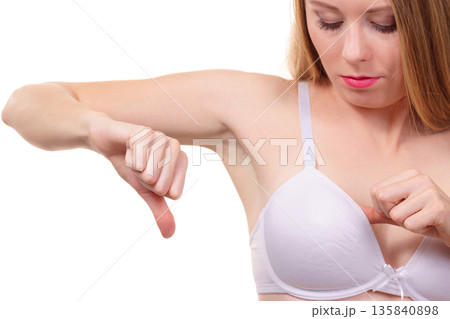 Woman dissatisfied with size of bra breasts 135840898