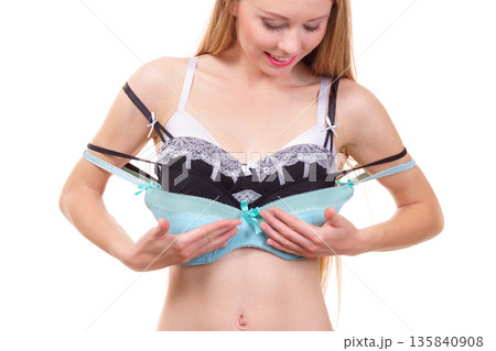 Woman holds bras, choosing Woman holds bras, choosing 135840908