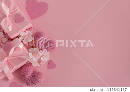 Gift Boxes, Knitted Hearts and Sakura Flowers. Romantic Valentines Day Flatlay on Pink Background Gift Boxes, Knitted Hearts and Sakura Flowers. Romantic Valentines Day Flatlay on Pink Background 135841137