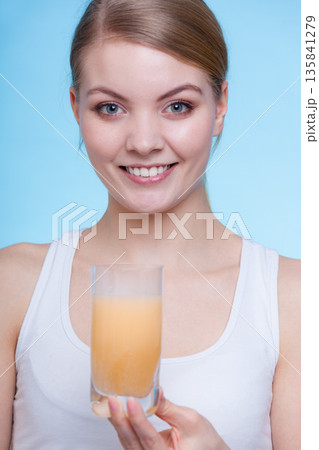 Woman holding glass with water and effervescent tablet Woman holding glass with water and effervescent tablet 135841279