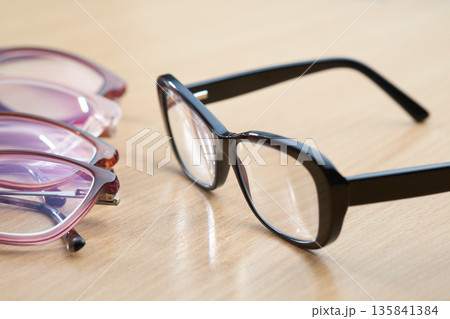 Multiple pairs of stylish glasses for vision correction and eye care. Selective focus. 135841384