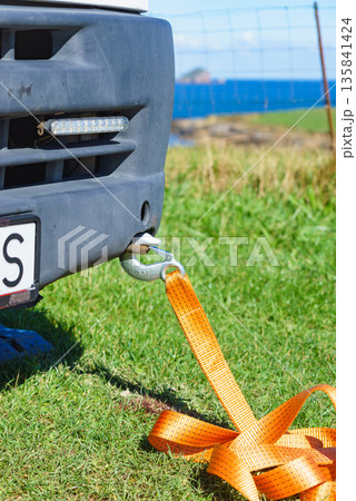 Tow hook with orange strap on car. Towing equipment. Tow hook with orange strap on car. Towing equipment. 135841424