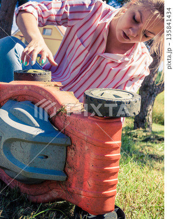 Person having problem with land mower Person having problem with land mower 135841434