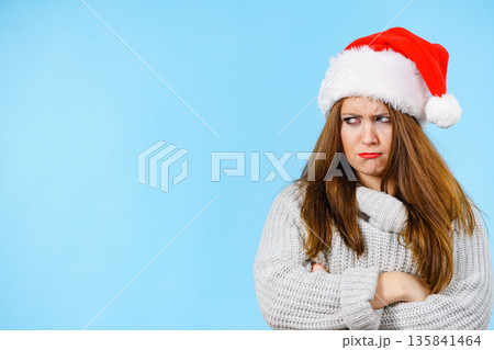 Tired woman wearing santa hat Tired woman wearing santa hat 135841464