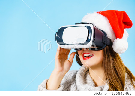 Girl watching 3d film tour in virtual reality glasses. Girl watching 3d film tour in virtual reality glasses. 135841466
