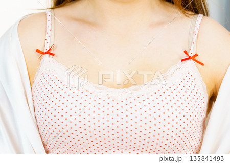 Woman in underwear shirt showing her neckline 135841493