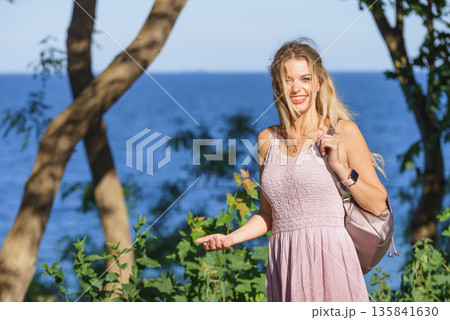 Hippie woman with backpack walking outdoor 135841630