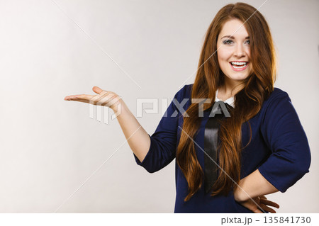 Happy elegant woman presenting copy space 135841730