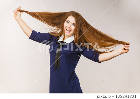 Happy positive woman with long brown hair Happy positive woman with long brown hair 135841731