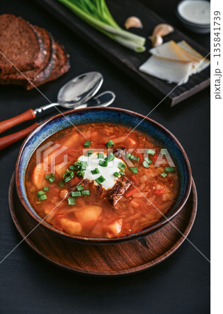 Bowl of red beetroot soup borscht with white cream 135841739