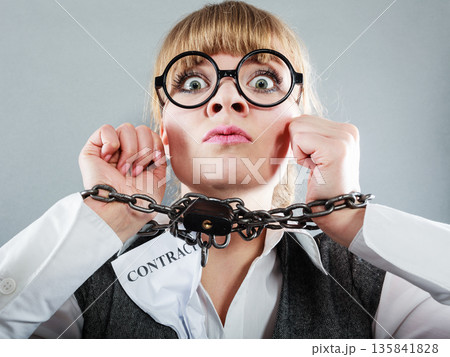Furious woman with chained hands and contract 135841828