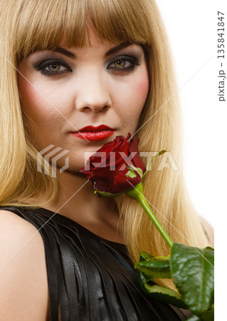 Woman gorgeous girl dark makeup holds rose flower Woman gorgeous girl dark makeup holds rose flower 135841847