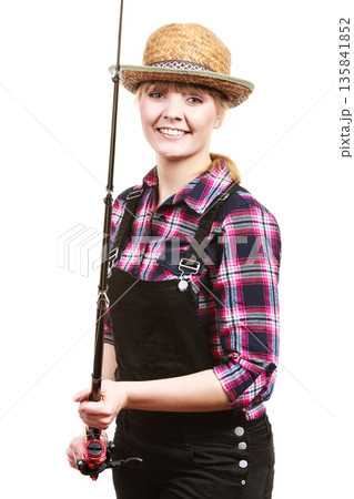 Happy woman in sun hat holding fishing rod Happy woman in sun hat holding fishing rod 135841852
