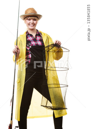 Happy woman holding fishing rod and keepnet Happy woman holding fishing rod and keepnet 135841855