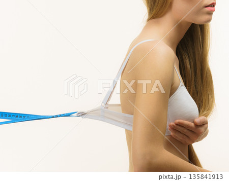 Woman wearing too big bra, loose band Woman wearing too big bra, loose band 135841913