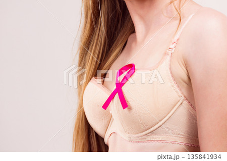 Woman chest in bra, pink cancer ribbon 135841934