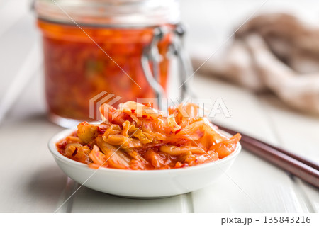 Fermented cabbage. Kimchi. Korean food in bowl on white table. 135843216