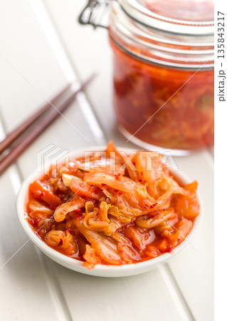Fermented cabbage. Kimchi. Korean food in bowl on white table. 135843217