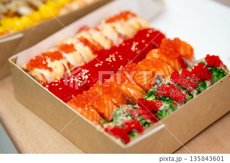 Assorted colorful sushi roll selection with salmon, caviar and seaweed salad 135843601