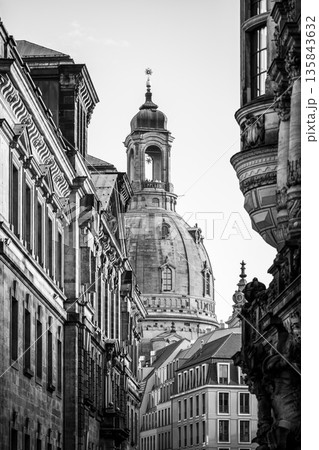 Frauenkirche rises above the buildings in Dresden. The dome is a prominent feature of the church and attracts visitors during the Christmas season. Streets are quiet in the winter light. 135843632