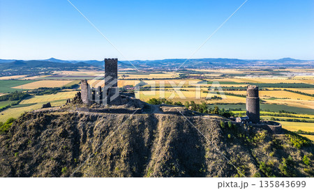 Nestled in the Central Bohemian Uplands, Hazmburk Castle ruins offer stunning aerial views of the surrounding landscape in Czechia, reflecting the grandeur of its medieval past. 135843699