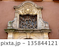 Ornate baroque window detail on historic townhouse facade 135844121