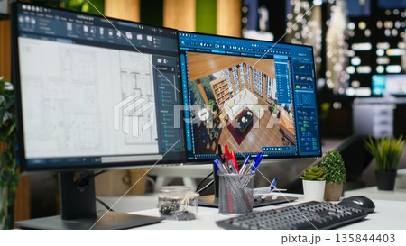 Empty design office with modern desk showcasing blueprint drafting and 3D modeling software on screen. Digital workspace emphasizes creative visualization in a professional environment. 135844403