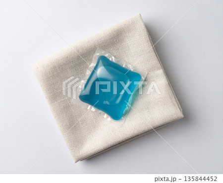 Gel caps. Soluble laundry detergent capsule on a neutral linen cloth with empty space for text. Gel caps. Soluble laundry detergent capsule on a neutral linen cloth with empty space for text. 135844452
