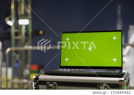 Green screen laptop on industrial drilling ship used to inspect equipment integrity. Mockup notebook on offshore platform used for performing machinery checkup to ensure safety, close up 135844482
