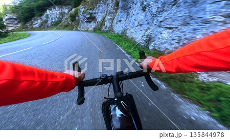 POV road cycling through rocky mountain gorge on winding alpine road POV road cycling through rocky mountain gorge on winding alpine road 135844978