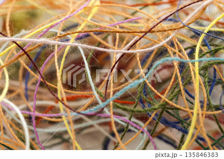 Multi-colored tangled colorful needlecraft silk thread rope. Macro shot. Abstract colors background 135846383