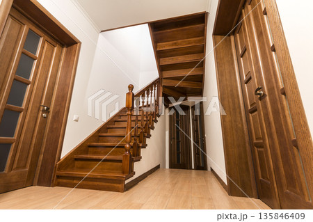 Modern brown oak wooden stairs and doors in new renovated house interior 135846409